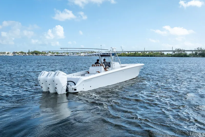 Slide: The Image of 2024 Bahama 41 boat cruising on open water under a clear blue sky. - 3