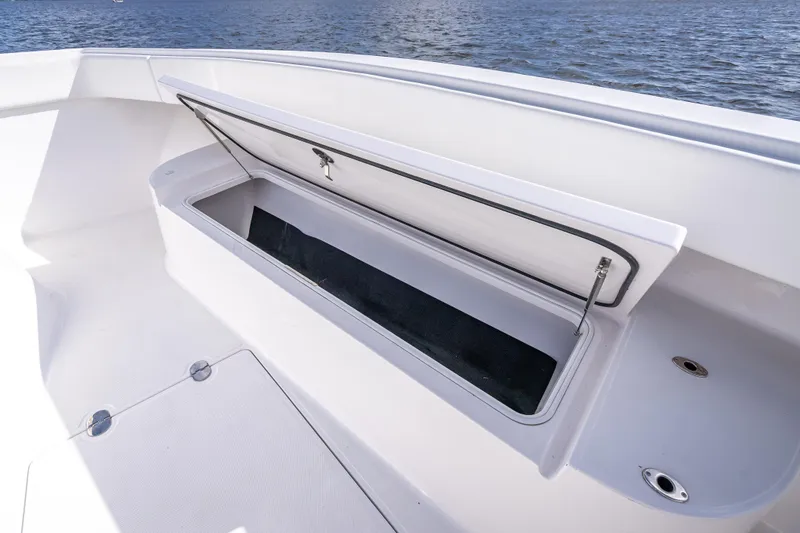 Slide: The Image of 2024 Bahama 41 boat storage compartment open, showcasing spacious interior design. - 31