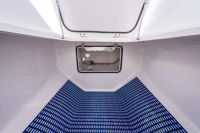 Slide: The Image of Interior view of 2024 Bahama 41 boat compartment with blue grid flooring. - 35