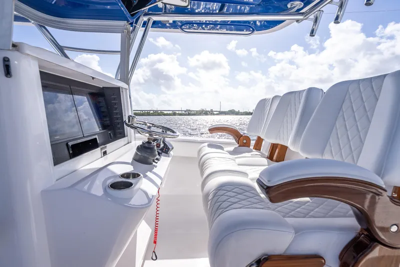 Slide: The Image of 2024 Bahama 41 boat interior with luxurious seating and modern helm controls. - 41