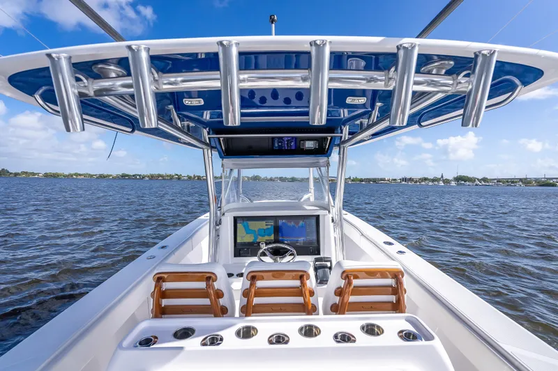 Slide: The Image of 2024 Bahama 41 boat interior with helm, ocean view, and blue sky. - 45