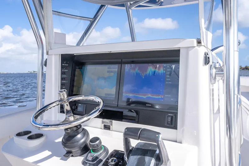 Slide: The Image of 2024 Bahama 41 boat helm with advanced navigation displays and steering wheel. - 46