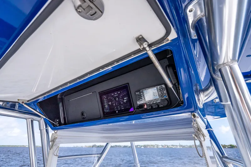Slide: The Image of 2024 Bahama 41 boat dashboard with navigation instruments and blue canopy. - 47