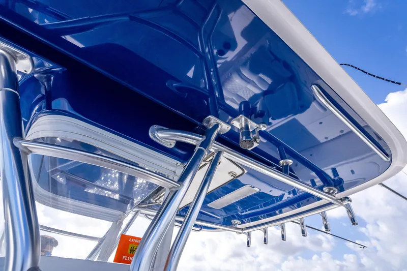 Slide: The Image of 2024 Bahama 41 boat with sleek blue canopy and stainless steel fittings against a cloudy sky. - 48