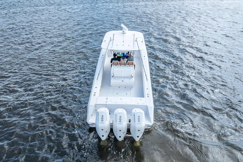 Slide: The Image of 2024 Bahama 41 boat with triple 400 engines cruising on open water. - 5