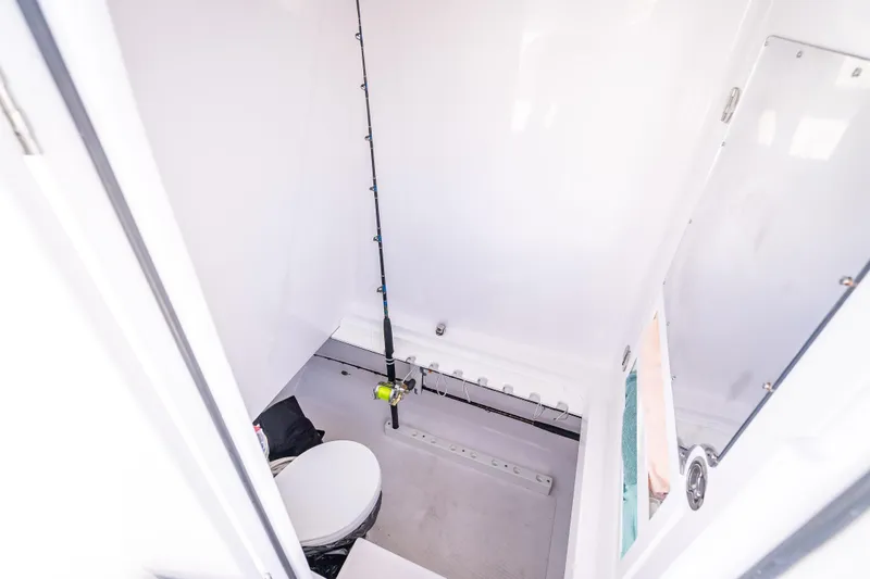 Slide: The Image of 2024 Bahama 41 boat interior with fishing rod and toilet. - 51