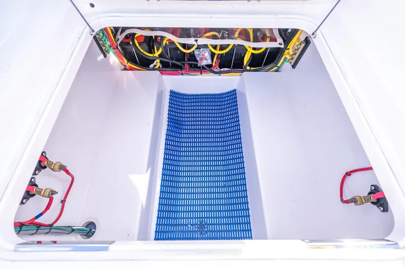 Slide: The Image of 2024 Bahama 41 boat compartment with wiring and blue mat. - 52
