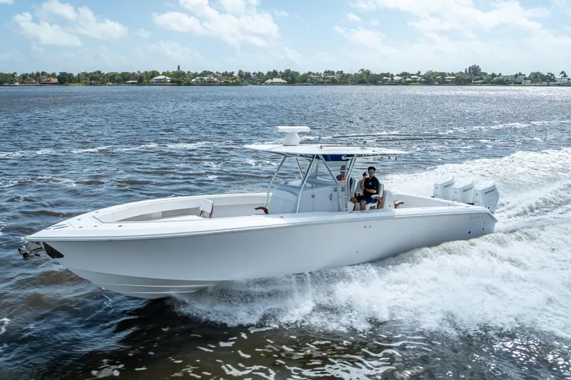 Slide: The Image of 2024 Bahama 41 boat cruising on open water under a clear sky. - 57