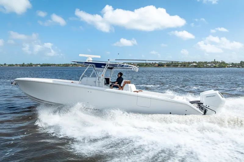 Slide: The Image of 2024 Bahama 41 boat cruising on open water under a clear blue sky. - 58