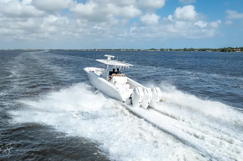 Slide: The Image of 2024 Bahama 41 boat cruising on open water with powerful engines. - 59
