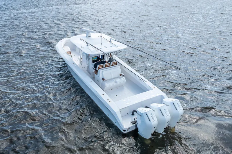 Slide: The Image of 2024 Bahama 41 boat with triple outboard engines on open water. - 6