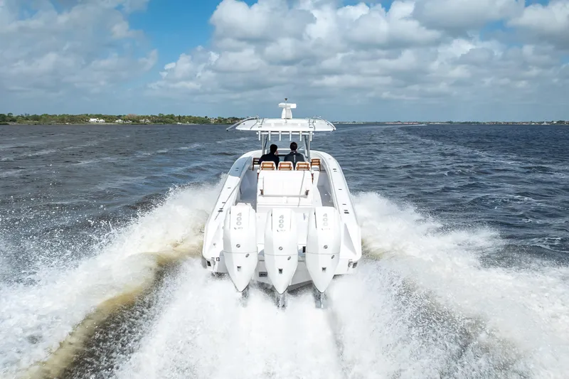 Slide: The Image of 2024 Bahama 41 boat cruising on open water with powerful engines. - 60