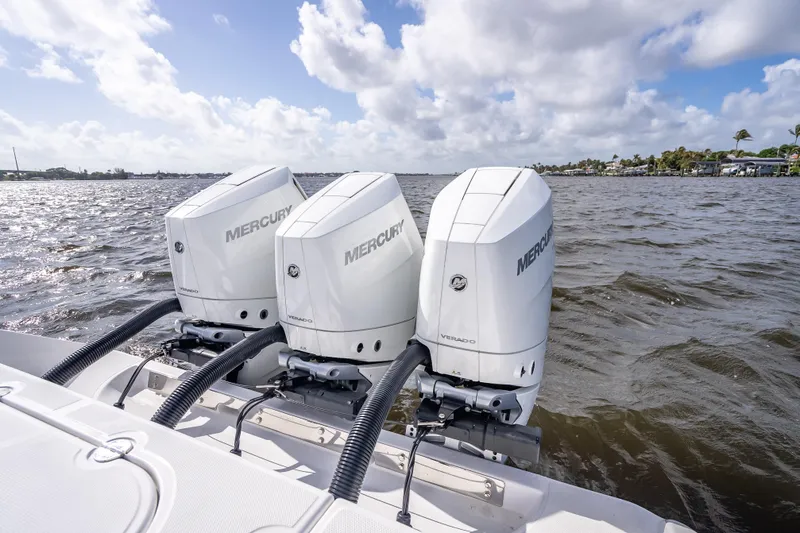 Slide: The Image of Triple Mercury Verado engines on 2024 Bahama 41 boat, cruising on open water. - 61