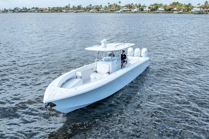 Slide: The Image of 2024 Bahama 41 boat cruising on calm waters, showcasing sleek design and powerful engines. - 8