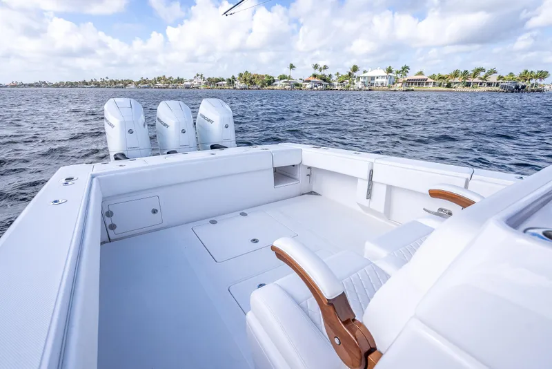 Slide: The Image of 2024 Bahama 41 boat with triple Mercury engines on calm water. - 9