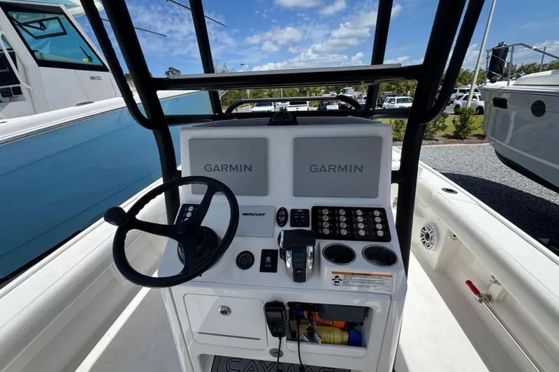 Slide: The Image of 2022 Caymas 26 HB boat console with Garmin displays and Mercury controls. - 12