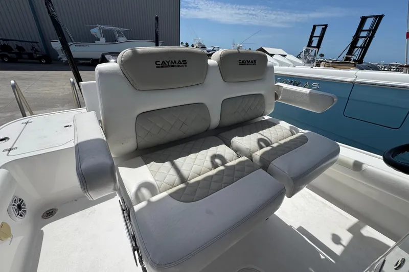 Slide: The Image of 2022 Caymas 26 HB boat with cushioned seating and elegant design. - 14