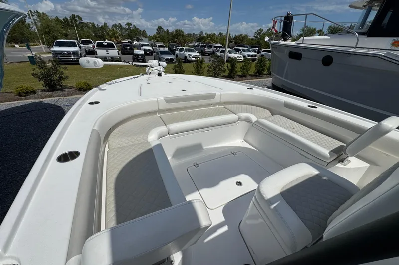 Slide: The Image of 2022 Caymas 26 HB boat interior with white seating and spacious deck. - 15