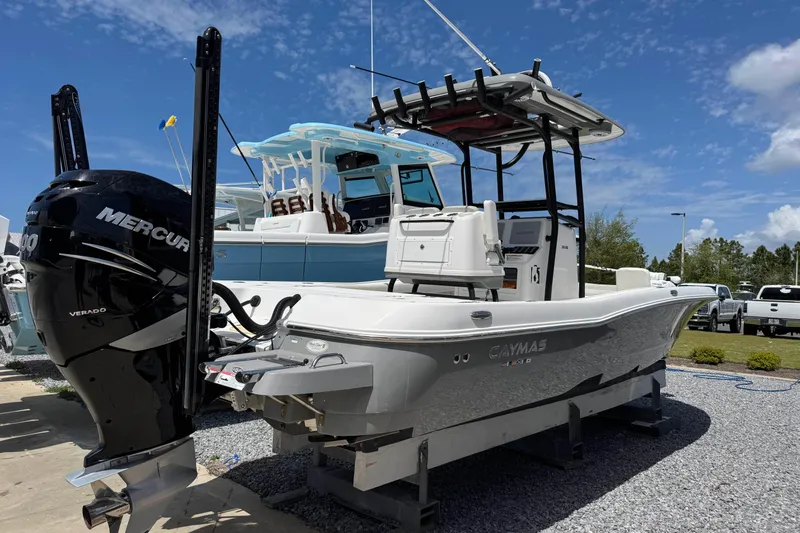 Slide: The Image of 2022 Caymas 26 HB boat with Mercury Verado engine, displayed outdoors under a clear sky. - 3
