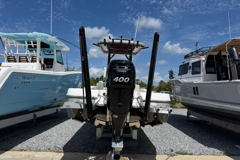 Slide: The Image of 2022 Caymas 26 HB boat with powerful 400 horsepower engine, displayed outdoors. - 4