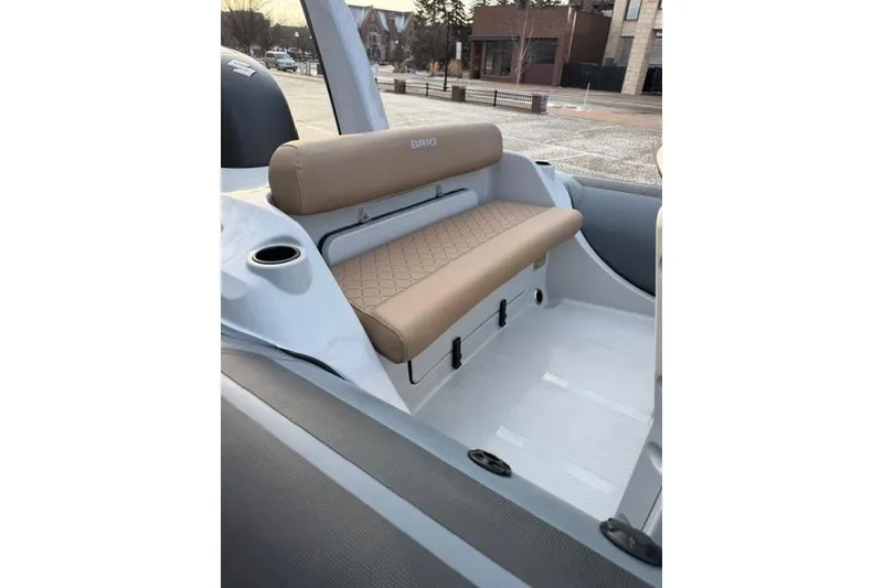 Slide: The Image of 2026 Brig Eagle 6 boat interior with tan seating and cup holder. - 3