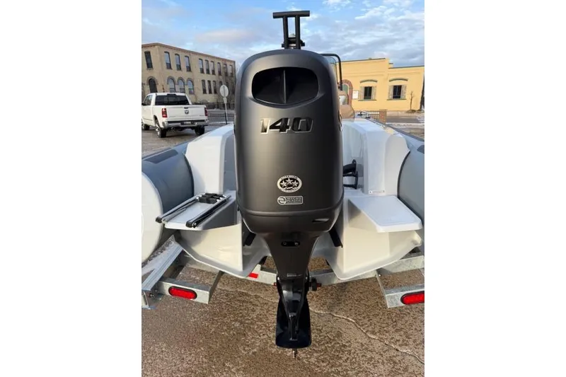 Slide: The Image of 2026 Brig Eagle 6 boat with a 140 horsepower outboard motor, parked on a trailer. - 4