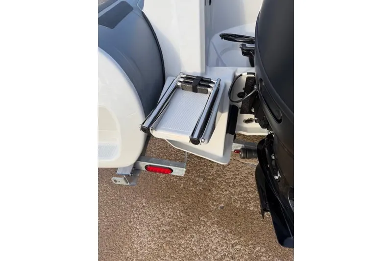 Slide: The Image of 2026 Brig Eagle 6 boat with a foldable ladder and motor detail. - 5