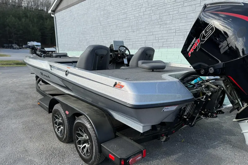Slide: The Image of 2026 iKon VLX21 boat with dual seats and powerful outboard motor on trailer. - 3