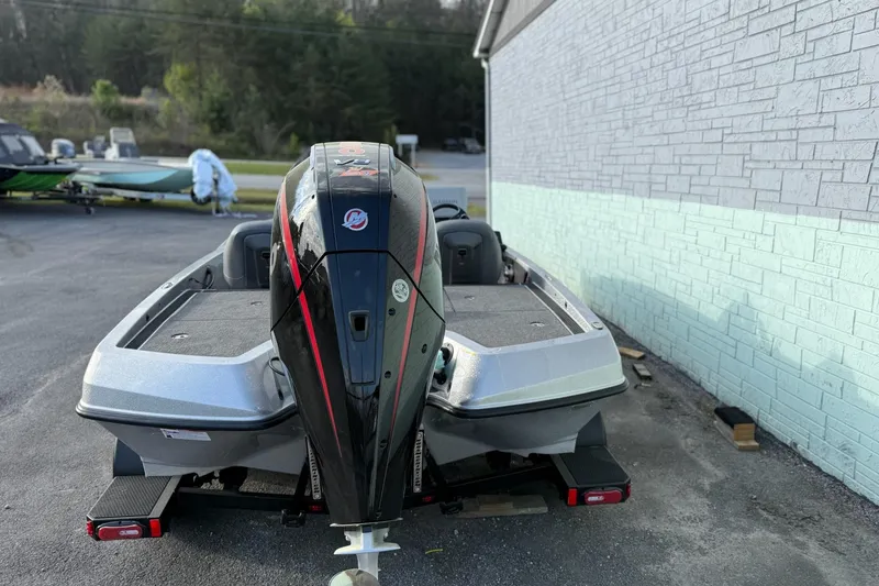 Slide: The Image of 2026 iKon VLX21 boat with powerful outboard motor, parked beside a brick wall. - 4