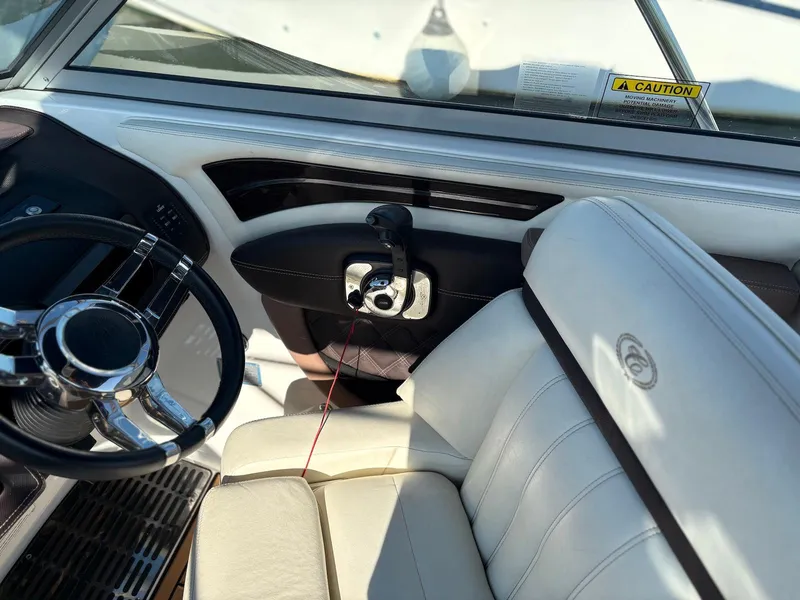 Slide: The Image of Interior of 2012 Cobalt A28 boat with steering wheel and leather seating. - 19