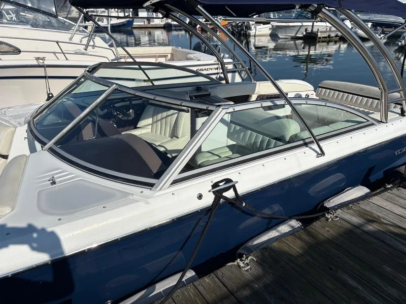 Slide: The Image of 2012 Cobalt A28 boat docked, featuring sleek design and spacious seating. - 2