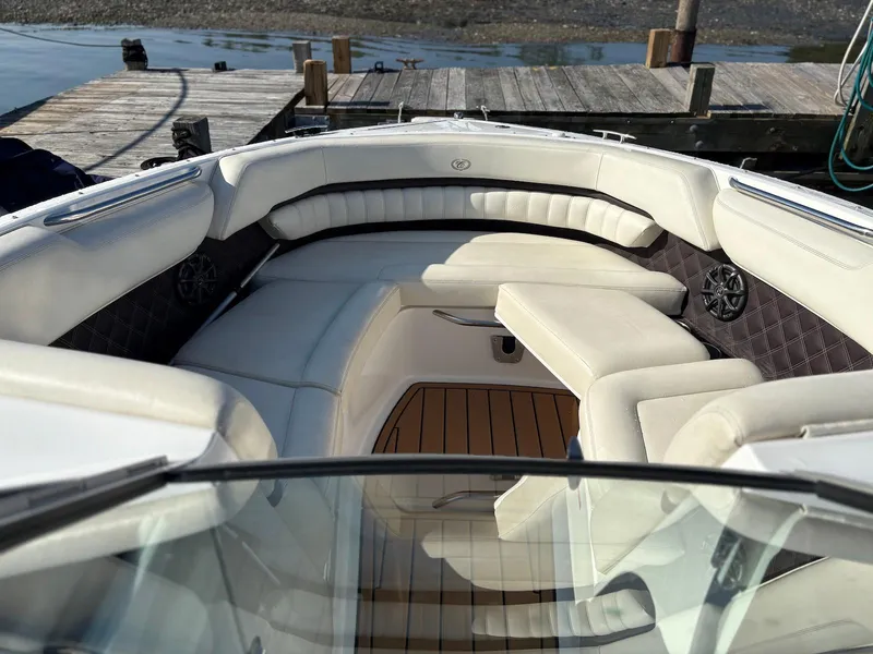 Slide: The Image of Luxurious interior of a 2012 Cobalt A28 boat with plush seating at a dock. - 20
