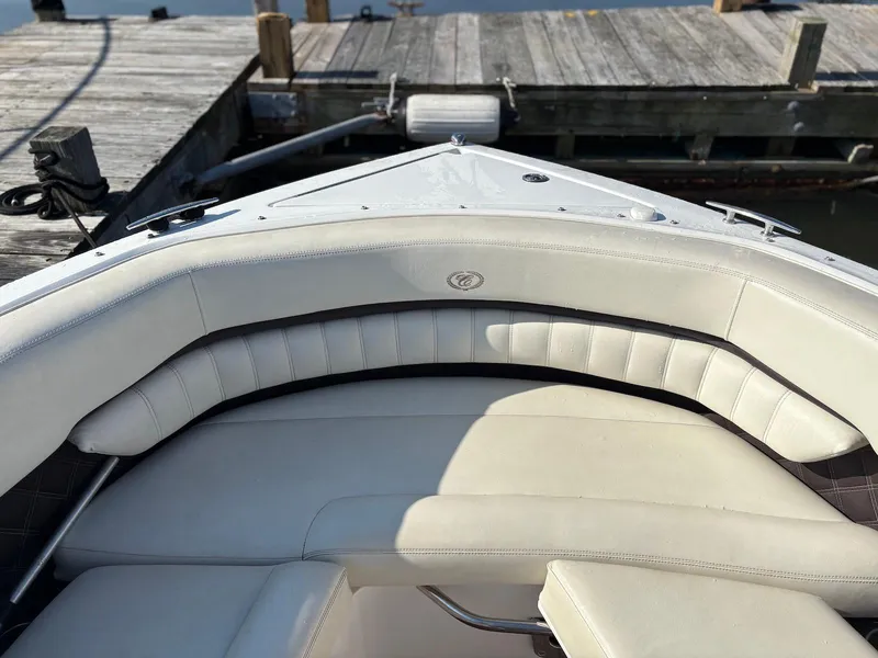 Slide: The Image of Bow seating area of a 2012 Cobalt A28 boat docked at a wooden pier. - 26