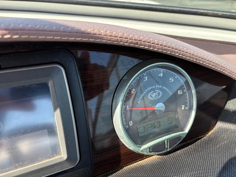 Slide: The Image of Dashboard of a 2012 Cobalt A28 boat showing RPM gauge and display screen. - 28