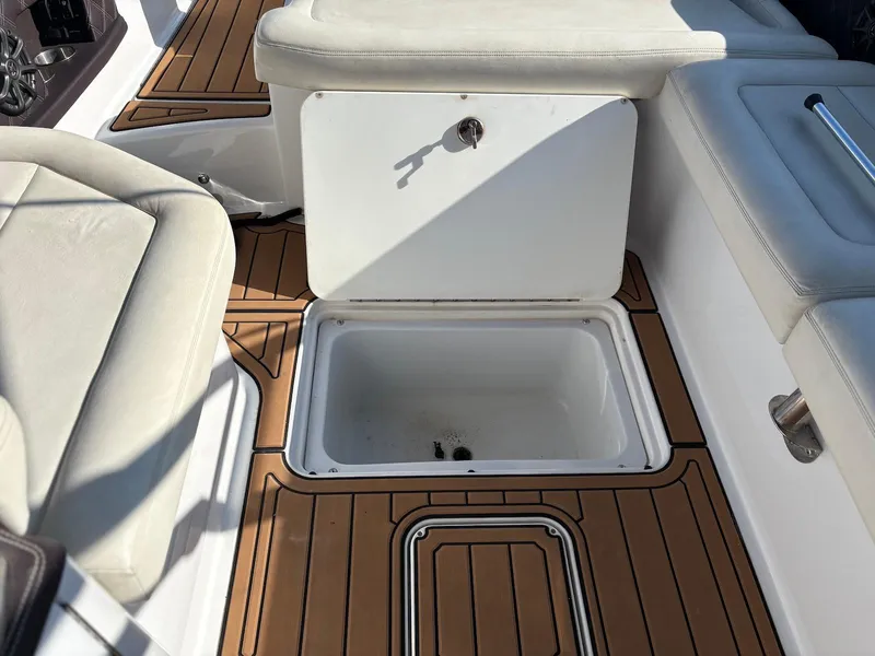 Slide: The Image of Cobalt A28 2012 boat interior with storage compartment and cushioned seating. - 29