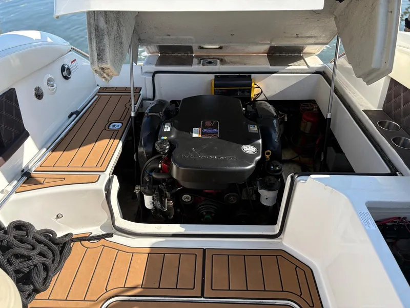 Slide: The Image of Open engine compartment of a 2012 Cobalt A28 boat, showcasing the engine and deck details. - 33
