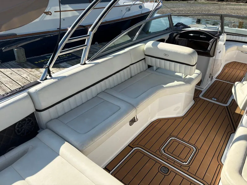 Slide: The Image of 2012 Cobalt A28 boat interior with white seating and teak-style flooring. - 7