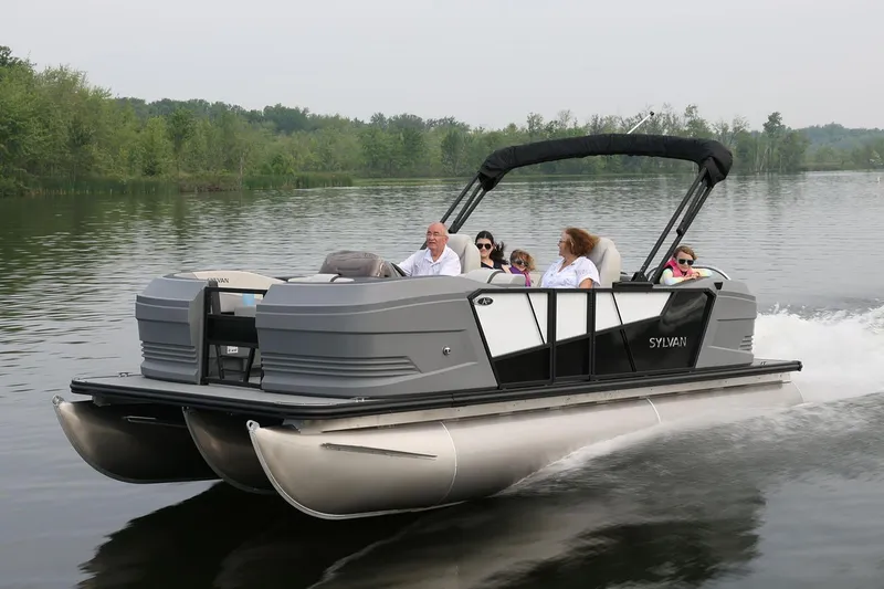 Slide: The Image of Manufacturer Provided Image: 2026 Sylvan A-Series 22 LZ DH Sport pontoon boat cruising on a serene lake. - 14
