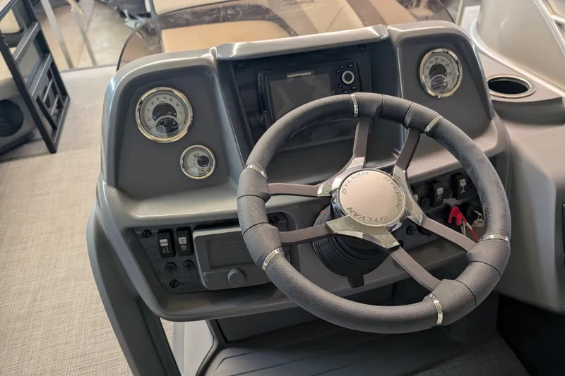 Slide: The Image of Steering console of 2025 Sylvan A-Series 22 LZ DH Sport boat, featuring modern controls. - 15