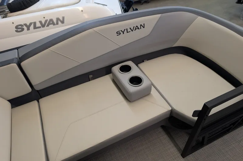 Slide: The Image of 2025 Sylvan A-Series 22 LZ DH Sport boat interior with cushioned seating and cup holders. - 2