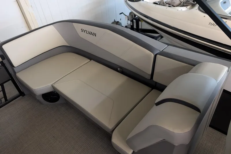 Slide: The Image of Luxurious seating on 2025 Sylvan A-Series 22 LZ DH Sport boat, featuring sleek gray upholstery. - 6
