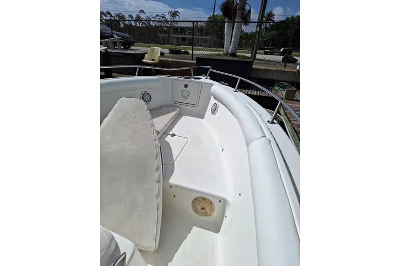 Slide: The Image of 2004 Century 2600 Center Console boat interior with cushioned seating and railing. - 3
