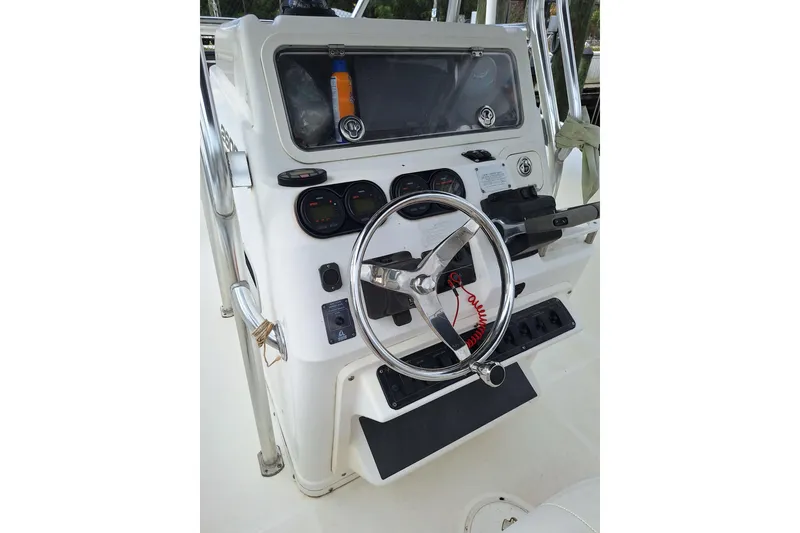 Slide: The Image of 2004 Century 2600 Center Console boat dashboard with steering wheel and gauges. - 6