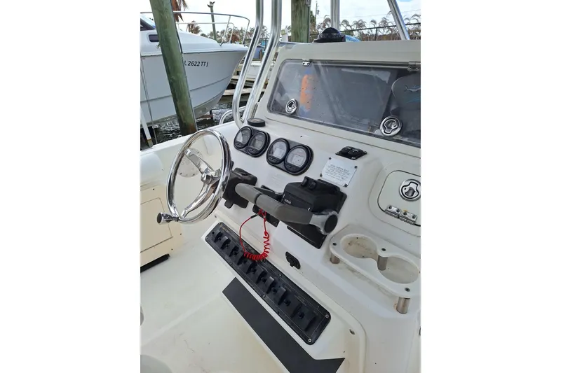 Slide: The Image of 2004 Century 2600 Center Console boat dashboard with steering wheel and controls. - 9