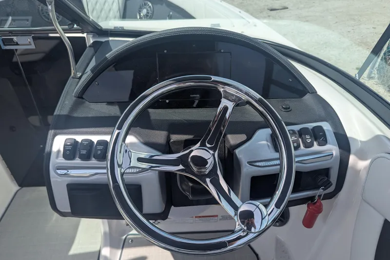 Slide: The Image of Steering wheel and dashboard of a 2025 Regal 21 OBX boat. - 10