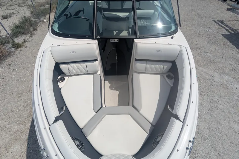Slide: The Image of 2025 Regal 21 OBX boat interior with white seating and cup holders. - 7