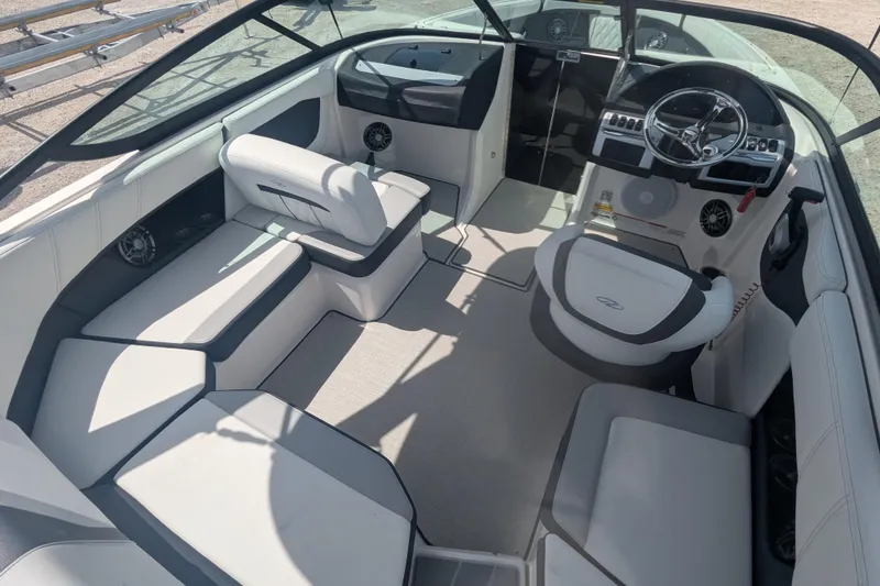 Slide: The Image of 2025 Regal 21 OBX boat interior with modern seating and sleek dashboard design. - 9