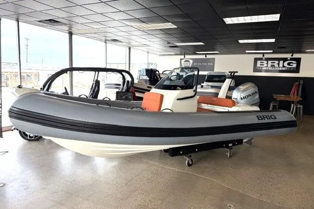 The Image of 2026 Brig Eagle 5 inflatable boat displayed indoors with Honda engine. - 0