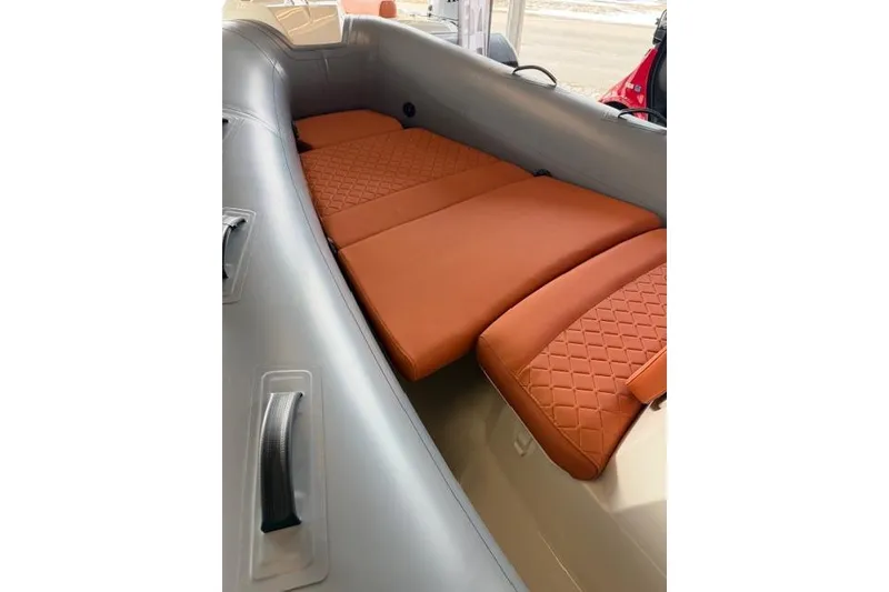 Slide: The Image of 2026 Brig Eagle 5 boat interior with orange quilted seating. - 5