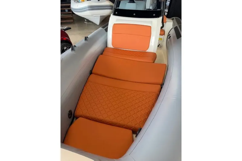 Slide: The Image of 2026 Brig Eagle 5 boat interior with orange cushioned seating. - 6